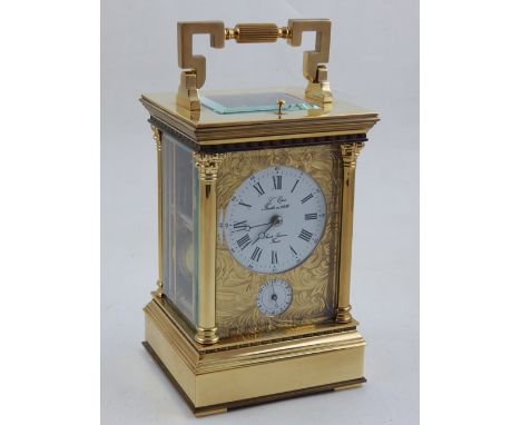A French gilt brass repeating carriage clock, the white dial with Roman numerals covered by foliate engraved front plate, sub