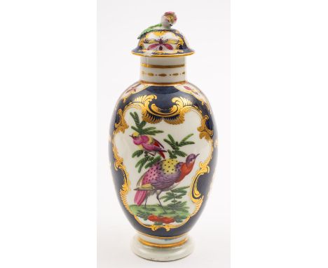 A First Period Worcester tea canister and cover with bud finial, the scale blue ground reserved with panels of fancy birds an
