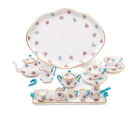 A miniature Crown Staffordshire miniature cabaret set. Comprising two trays, teapot (damaged), chocolate pot, two jugs, turee