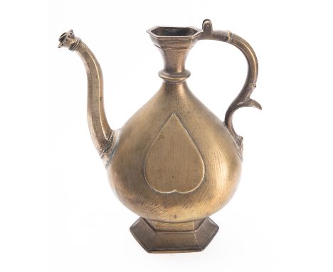 An Indian bronze ewer, 18th century the body cast with heart shaped motifs, on hexagonal base, 29cm [lacking lid].
