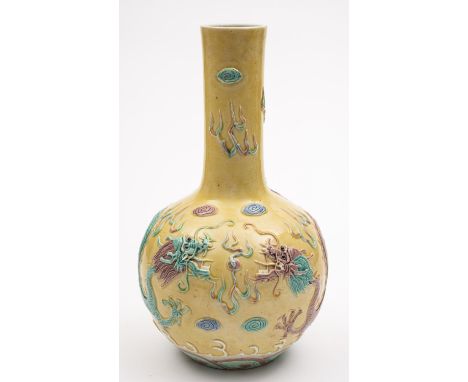 A Chinese porcelain vase of globular form with raised neck modelled in relief with a pair of dragons competing for a pearl, r