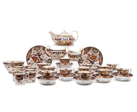 An early 19th century Derby part tea coffee service, in an Imari pattern comprising a teapot, milk jug, sugar bowl, cake plat