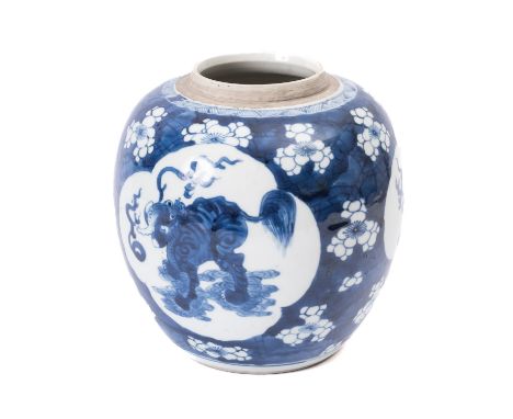 A Chinese porcelain oviform jar, painted in blue and white with three quadrilobed panels containing a Qilin, reserved on a cr