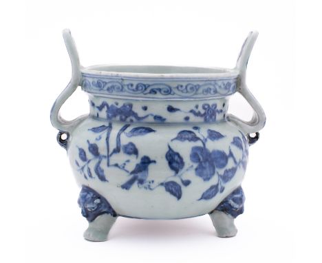 A Chinese blue & white tripod vessel of 'Ding' form with curved upright handles, painted with birds, branches of peaches and 