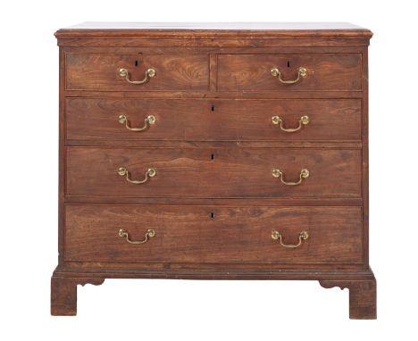A George III stained exotic hardwood, possibly Chinese elm, chest of drawers, late 18th Century; the top with moulded edges, 