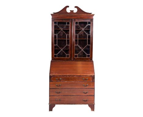 A mahogany and glazed bureau bookcase in George III style, early 20th Century; The 'broken' pediment above two glazed panel d