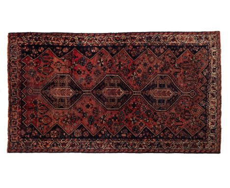  A Lori rug, the rose field with triple indigo hexagonal hooked pole medallions, all over designs and indigo surround, enclos