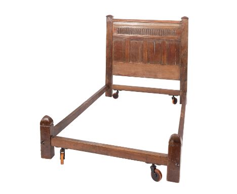 An oak bedstead, elements 17th Century and later constructed; the headboard with moulded top rail above fluted frieze, above 