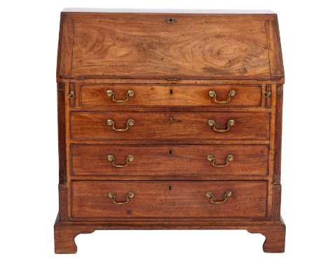 A George III mahogany bureau, circa 1800; the hinged fall front opening to reveal a fitted interior with drawers and central 