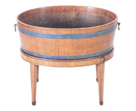 A 19th Century mahogany inlaid and brass bound oval wine cooler, with brass carrying handles on a stand with square tapered l