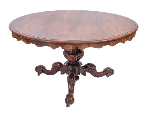 A William IV rosewood circular breakfast table, circa 1835; the top with moulded edges above serpentine undersides; the block