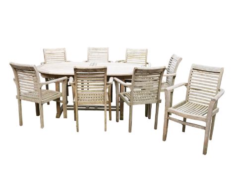 A suite of teak garden furniture, comprising an extending dining table and eight elbow chairs, modern; the oval table 75cm hi