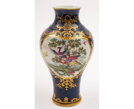 A First Period Worcester baluster vase painted with two panels of fancy birds in classical landscapes within elaborate gilt r