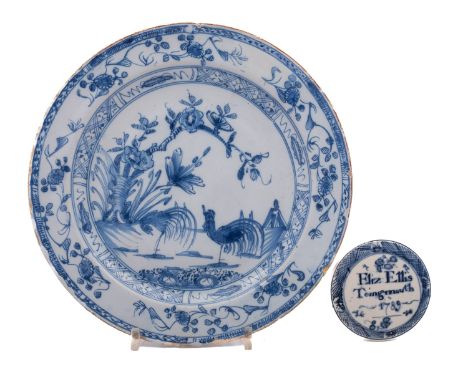 An 18th century English blue and white delftware plate and a Bovey Tracey inscribed and dated creamware cover the plate paint