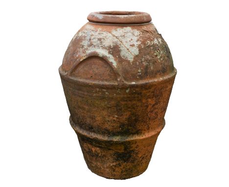 A large terracotta jar, probably Italian, early 20th century; of ovoid form, with ribbed exterior and two simple moulded hand