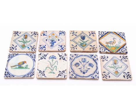 A group of eight Dutch delftware tiles, late 17th/early 18th century comprising a set of three polychrome tiles painted with 