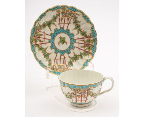 A First Period Worcester 'Hop Trellis' teacup and saucer of lobed form, painted with garlands of berried foliage between turq