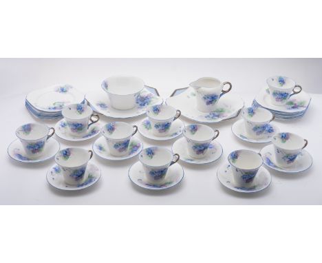 A Shelley porcelain Regent tea service in the Violets pattern, comprising eleven cups, ten saucers, sugar bowl, cream jug, tw