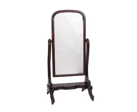 A Victorian mahogany cheval mirror, circa 1875; the shallow arched plate held in twin serpentine supports; above a serpentine