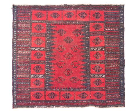 A Turkoman flatweave rug, the field with a central wine ground panel with lozenge medallions, tomato red surrounding lozenge 
