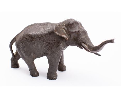 A Japanese bronze elephant, signed Seiya, Meiji period naturalistically modelled with trunk raised, 18cm long.
