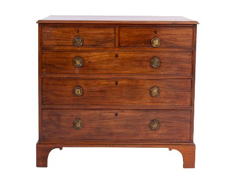 A George III mahogany chest of drawers, late 18th Century; the top with moulded edges, above two short and three long drawers