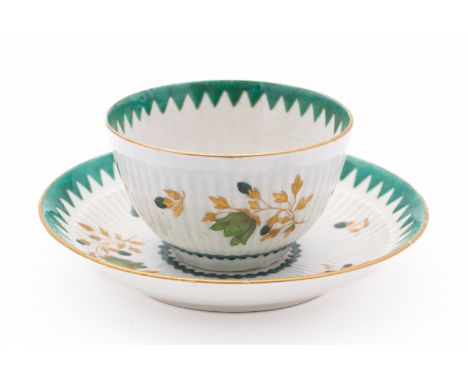 A First Period Worcester teabowl and saucer of semi-reeded form, painted and gilded with scattered flower sprays within 'Fren