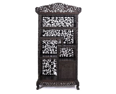 A Chinese carved and stained hardwood, probably zitan, open display cabinet, 19th Century; the openwork cresting carved with 