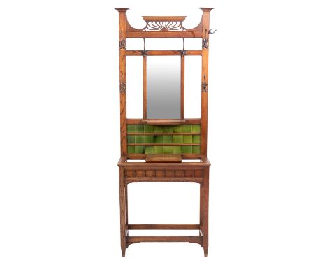A Victorian oak and ceramic tile inset hallstand, in Arts & Crafts style, circa 1900; with openwork cresting of radiating scr