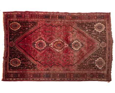 A Shiraz carpet, the rose hexagonal field with triple hexagonal stepped medallions, all over stylised floral foliate stems an