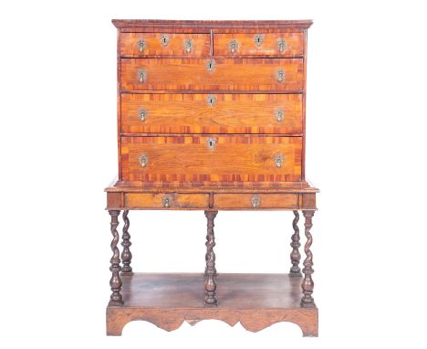 A George II oak and walnut banded chest on stand, mid 18th century and later; with moulded cornice above two short and three 