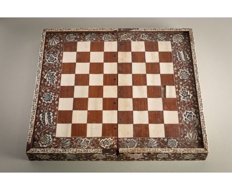 An Anglo-Indian, probably Vizagapatam ivory inlaid rosewood folding games box, circa 1800; the exterior with chess board with