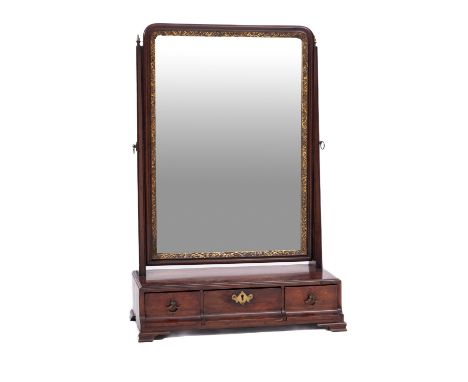 A mahogany dressing table mirror in George II style, 19th Century; the rectangular bevelled plate with gilt slip, angle adjus