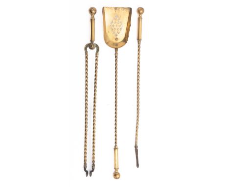 A set of brass fire tools, early 20th century; comprising shovel, poker and tongs; the grips all with sphere finials, on writ