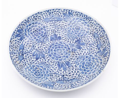 Two Chinese blue and white chargers, late Qing dynasty/20th century one painted with flowers and rockwork in fan-shaped panel