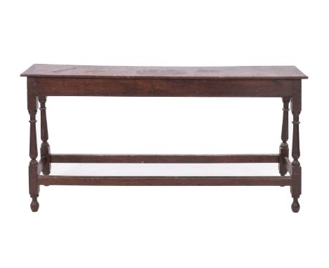 An oak long box stool in Jacobean style, late 19th Century; the hinged top opening to a vacant interior on knop turned suppor