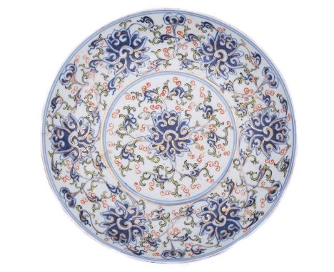 A Chinese 'Lotus Scroll' dish, of shallow circular form decorated with under glaze blue and copper red and green enamel with 
