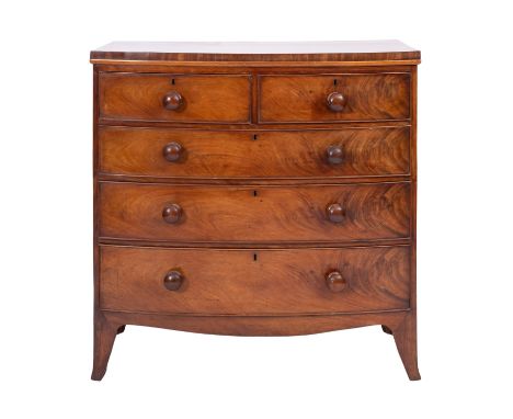 A Regency mahogany bow front chest of drawers, circa 1815; the two short and three graduated long drawers all with turned bun