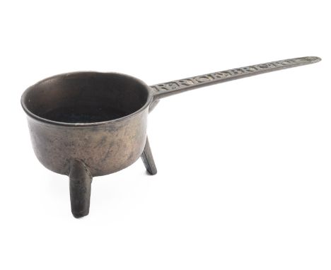 A George III bronze skillet, later 18th century; the circular pan on three straight legs, the straight handle cast with the R