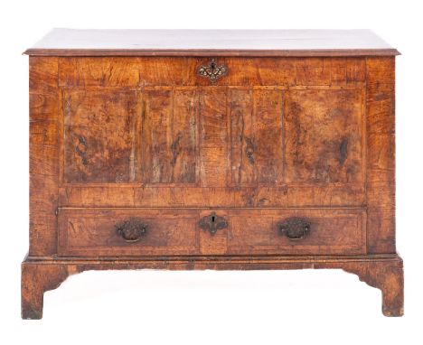 A George II walnut and cross banded dowry or mule chest, circa 1740; the hinged top with ogee moulded edges; the panel veneer