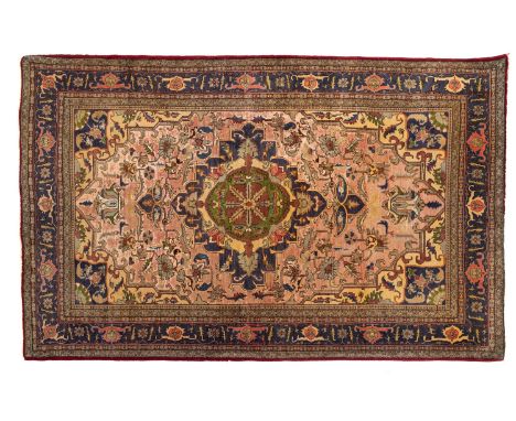  An Aredbil part silk rug, the peach field with a central shaped lozenge pole medallion in indigo, green, pistachio and plum 