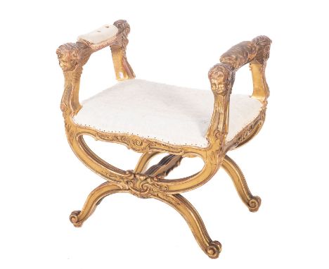 A carved and giltwood dressing table stool or window seat in Louis XV style, late 19th /early 20th century; the padded armres