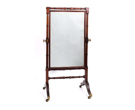 A Regency mahogany cheval mirror, by Wilkinson of London, circa 1815; the rectangular plate with a reeded border, inscribed '