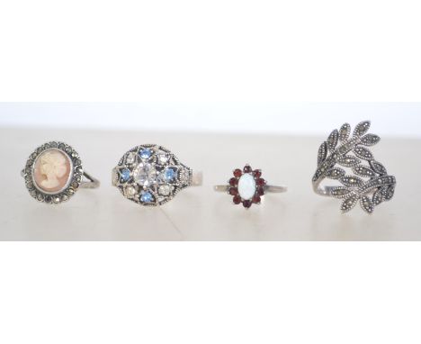 A group of 4 silver 925 dress rings to include a naturalistic marcasite leaf ring, a ring with a central clear stone with blu