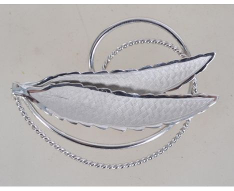 A contemporary Canadian silver brooch with roller clasp in the form of feathers with spiral backing and frosted finish . Mark