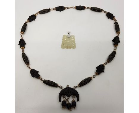 A Chinese mutton jade pendant, pierced and carved to one side, length exc. bail 38mm, together with a carved sandalwood bead 