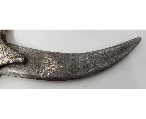 A 19th century Indian dagger, with curved damascus blade, bone grip and koftgari silver inlaid blackened steel guard, pommel 