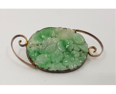 A silver gilt mounted mottled green jade floral brooch, pierced and carved, length 5.5cm.&nbsp;