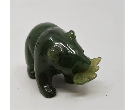 A carved spinach jade of a bear holding a fish,&nbsp;length 3.3cm.