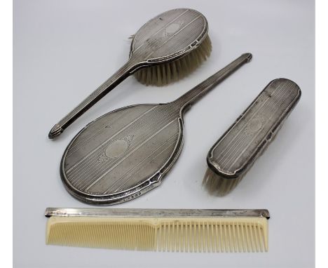 A silver mounted four piece dressing table set, by Daniel manufacturing Company, assayed Birmingham 1945, with engine turned 